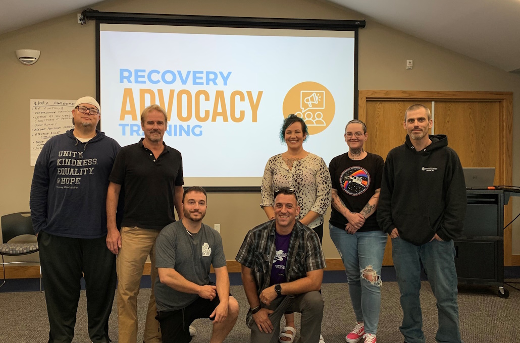 Members of the Advocacy team in front of a presentation screen